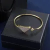 Роскошный браслет из белого черного золота с треугольником