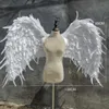 純粋な白い曲がりくねった天使の翼自然羽の大きな妖精の妖精の翼結婚式の誕生日パーティー装飾雑誌撮影アクセサリー206t