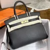 Bola de couro Platinum Luxurys Bolsa Top Top 2024 Linha de cera da fivela de primavera Togo Calfskin Lichchee Grãe Manual feminino