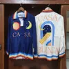 Chemises décontractées pour hommes Hip Hop Miracle Gate Orange Moon Print Rayures colorées Casablanca Manches longues Chemise de plage hawaïenne de haute qualité 230718