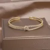 Braccialetto di design gioielli di moda 14k placcato oro rame intarsiato zircone serpente braccialetto aperto accessori per feste da donna di lusso 230719