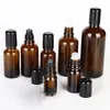 Rouleau en verre ambre en gros sur des bouteilles 5 ml 10 ml 15 ml 20 ml 30 ml 50 ml Conteneurs en verre de 100 ml d'épaisseur avec rouleaux SS et couvercles noirs sur la promotion XEBW