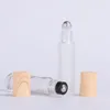 Bottiglie di rullo di vetro all'ingrosso per essenza di crema cosmetica Rotolo vuoto ricaricabile sul contenitore 10 ml 650 pezzi / lotto con grana di legno plastica Rgna