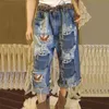 Женские джинсы разорванные кисточки с кисточка