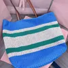 Classic designer tote bag Woven fabric vibrant color-block pattern animates this crochet handbag embroidered lettering shoulder bag leather handles