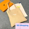 Classique grande capacité avec logo sac en toile Ins Style sacs fourre-tout faciles à assortir cadeau sac sous les bras beaux sacs écologiques