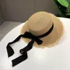 Cappelli a tesa larga fatti a mano da donna estate cappello da sole spiaggia rafia Panama berretto di paglia grande fiocco nero bianco nastro temperamento piatto taglio UV