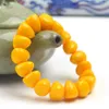 Mode kinesiska 15 13mm gula bivax pärlor bärnstensregel elastiska armband män kvinnor mala meditation smycken lycka gåvor new303w