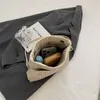卸売り女性ショルダーバッグ5色ニッチデザインソリッドカラー縫製ファッションハンドバッグ