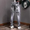 Gris Jeans Patchwork desgastado Whisker-Washed Slim Fit para hombres