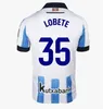 Maillots de football de la Real Sociedad 2023/24 2024 OYARZABA MERINO CARLOS FDEZ SADIQ ARITZ Shirt Hommes TAKE BARRENE PACHECO BRAIS MENDEZ LE NORMAND Uniforme de football Kit enfant