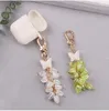 Keychains Creative Glitter Butterfly Plating Lily of the Valley Hanging Bead Key Ring Case Airpods Women Bag Car Pendant Keyring