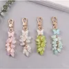 Keychains Creative Glitter Butterfly Plating Lily of the Valley Hanging Bead Key Ring Case Airpods Women Bag Car Pendant Keyring