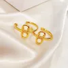 New designed TRIOMPHE Arch hollow out Hoops EARRINGS IN BRASS WITH GOLD SHINY WOMEN EAR HOOPS Designer Jewelry CE LINEmnb555