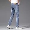 Calças de brim masculinas designer de luxo marca de moda jeans primavera nova elástica magro pé wear branco azul calças hxwj