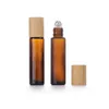 Rouleau de verre vide cosmétique de 1/2 OZ sur des bouteilles d'emballage de parfum givré transparent ambre avec boule en métal et couvercle en bambou