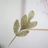 Pianta di simulazione di plastica di simulazione di foglie di polvere d'oro di Natale Decorazione di festival di foglie di albero di Natale Layout di plastica all'ingrosso