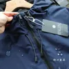 Vestes pour hommes Gmiixder Cargo Veste à capuche coupe-vent imperméable demi-zip pull manteau niche patch designs vintage fermeture éclair haut