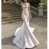 Abiti da sposa bohémien senza maniche Abiti da sposa con applicazioni di pizzo illusione Abiti da sposa con scollo a V da spiaggia