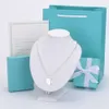 Tiffanybead Kolye Tiffanyjewelry Desginer Beyaz Bakır Gümüş Kaplama T Anahtar Kalp Şeklinde Buda Boncuk Kolye Kadınlar için CNC Çelik Mühür Mektubu Aşk Kolye Tur B