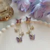 Kolczyki Dangle Koreańskie kolce mody biżuteria fioletowa symulacja motyla Pearl Stud Tassel Oświadczenie dla kobiet hurtowych