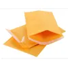 Nouveau 100pcs / lots Bubble Mailers Sacs Enveloppes rembourrées Emballage Sacs d'expédition Kraft Bubble Mailing Enveloppe Sacs 130 * 110mm Cbmgr