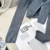 女性デザイナーセータースレッドニットセーターが積み重ねられた2ピースの長袖カーディガンレディスネックハイティングトップス