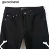 Mężczyźni dżinsy 23ss Nowe chude dżinsy designerskie spodnie RIP Slim Fit with Bone Black Biker Dżins Motorcycle Trendy Knee Otwór Długa prosta dżinsy męskie spodnie