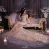 Bruiloft sprankelende sexy jurk pure bling kralen kant applique hoge hals illusie lange mouw champagne zeemeermin kapel bruidsjurken