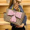 2024 New Designer women's crossbody shoulder can be and mixed batches parent-child children's hand-held personality niche bow hand carry bag