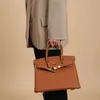 2024デザイナーバッグトーゴカーフレザーハンドメイドハニーライン本革女性リッチパターンロックボタンハンドバッグ