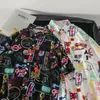 Męskie zwykłe koszule Harajuku ciemna ikona drukowana koszula na hawajskie koszulę Summer Men Shirt krótkie rękawowe odzież uliczna Hawaje Button Lapel krótkie rękawy 230411