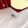 Bijoux de créateurs Gold Hommes et femmes doubles anneaux ovales Micro Diamond Pendant Collier Fashion Titane en acier en acier chaîne