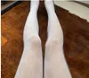 Seksowne długie pończochy Kobiety moda czarno -białe cienkie rajstopy miękka pusta litera ciasna majtki