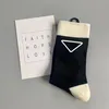 Fashionable luxury P family Christmas vintage gold lettered leather triangle badge design solid color minimalist basic mid tube trendy women's socks ins