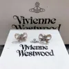 Fashion del diseñador 24SS Viviennewestwood Diamond Bowknot Pendientes de Saturno para aretes de nuevo estilo de las mujeres Pendientes de lujo de luz de altura junior New 2023