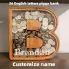 Novelty Items Twenty six Letter Piggy Bank Wooden Coin Money Saving Box Jar Coins Storage Desktop Ornament Home Decor Crafts Xmas Gift 231115