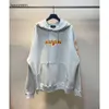 Designer hoodie balencigs mode hoodies hoody mens tröjor hög kvalitet b familjen delad tryck stänk av bläck huva med trasigt tryck på framsidan och vänster armar si3j