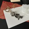 Luxury KeyChain Nyckel Varumärkesdesigners Figur Tecknad nyckelringar för män Kvinnor Copper Car Purse Pendant Lanyards Tillbehör