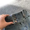 Jeans voor heren Mode blauw Persoonlijkheidsknop Micro uitlopende jeans Vintage streetwear gewassen slim fit Sexy Babes Rechte pijpen Casual broek 231116