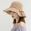 Chapéus largos da borda Mulheres Summer Summer Travel Straw Hat Straw Bow Wavy Big Cool Fashion Moda dobrável Pesca Pescador Cap vestuário férias de férias