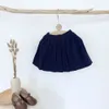 Юбки Осень Зимняя девочка вязаные юбки в корейском стиле сплошной малыши дети плизили линейные юбки 230417