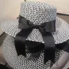 Szerokie brzegowe czapki HT067 Sun Hat upf 50 Ladies Big Bowknot Straw Summer Summer Beach Cap Fedoras Sukienka