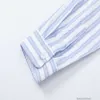 Designer Chemises pour hommes Mode Vêtements décontractés Mode Br Ami Été Nouvelle chemise à manches longues avec des rayures bleues Coeur brodé Revers Couples la même chemise Ami