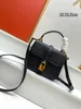 Mini bolso de cuero de vaca brillante de lujo Bolso de hombro de diseñador de moda Bolso cruzado de concha Accesorios de metal Bolso con cabeza con cerradura recomendado por celebridades de Internet