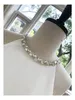 2023 Sommar Vit Enfärgad Pärl Klänning Ärmlös Rhinestone Midi Casual Klänningar med rund hals Y3A207430