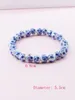 Bracciale elasticizzato con perline di porcellana bianca e blu in ceramica cinese