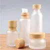 Bouteilles de crème de pot en verre givré pots cosmétiques ronds bouteille de pompe de lotion pour le visage avec bouchon en grain de bois Vxntg