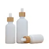 Bouteilles d'huile essentielle en verre de porcelaine blanche Flacon compte-gouttes de sérum de soin de la peau avec pipette en bambou 10 ml 15 ml 20 ml 30 ml 50 ml 100 ml Wbjuv