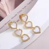 Boucles d'oreilles à tige européenne et américaine Fashion Love incrustées de collier pendentif en forme de coeur en forme de coeur avec coquille de zircon scintillant